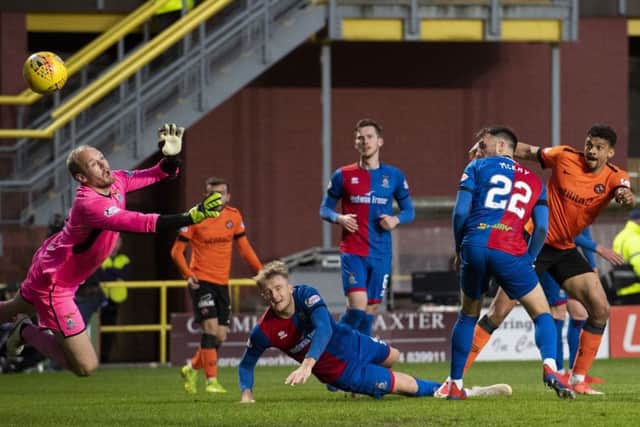 Osman Sow, far right, watches his shot on the turn fly past goalkeeper Mark Ridgers to give Dundee United a two-goal lead. Picture: SNS.