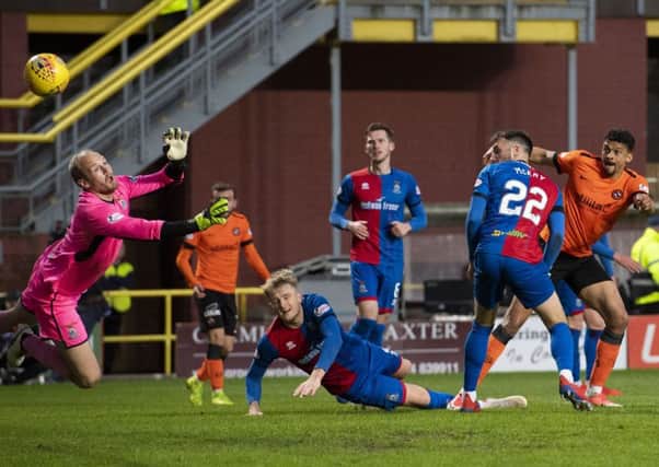 Osman Sow, far right, watches his shot on the turn fly past goalkeeper Mark Ridgers to give Dundee United a two-goal lead. Picture: SNS.