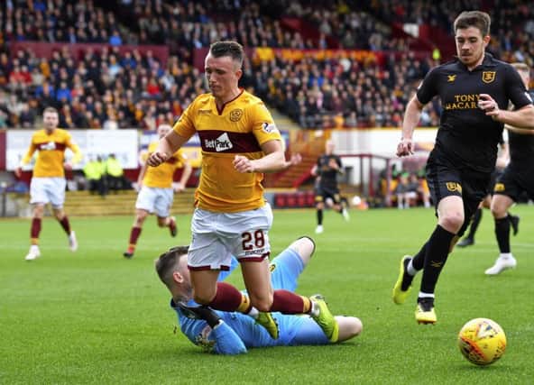 Motherwell's David Turnbull is brought down by Livingston goalkeeper Ross Stewart and a penalty is awarded. Picture: SNS