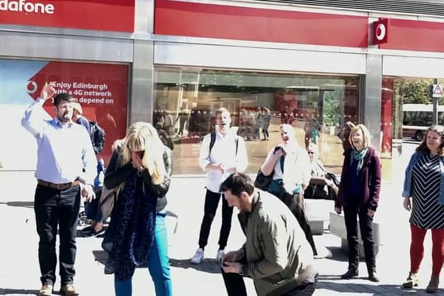 This is the heartwarming moment a man proposed to his girlfriend in the street where they first kissed. Picture: SWNS
