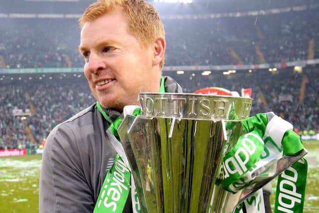 Neil Lennon hugs the trophy which Celtic won for an eighth consecutive time. Picture: PA.