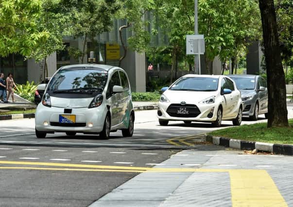Driverless cars, such as the one pictured left,  have been found to improve traffic flow. PIC Roslan Rahman/AFP/Getty Images.