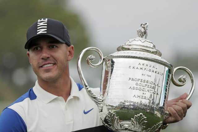 Brooks Koepka holds up the Wanamaker Trophy after winning the US PGA Championship at Bethpage Black. Picture: AP