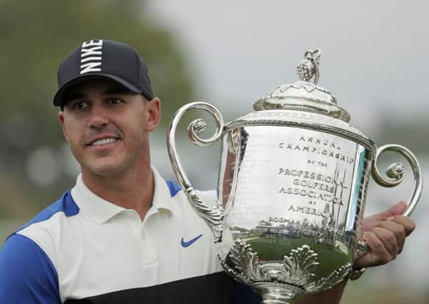 Brooks Koepka holds up the Wanamaker Trophy after winning the US PGA Championship at Bethpage Black. Picture: AP