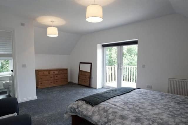 The master bedroom has access to the balcony and modern en suite.
