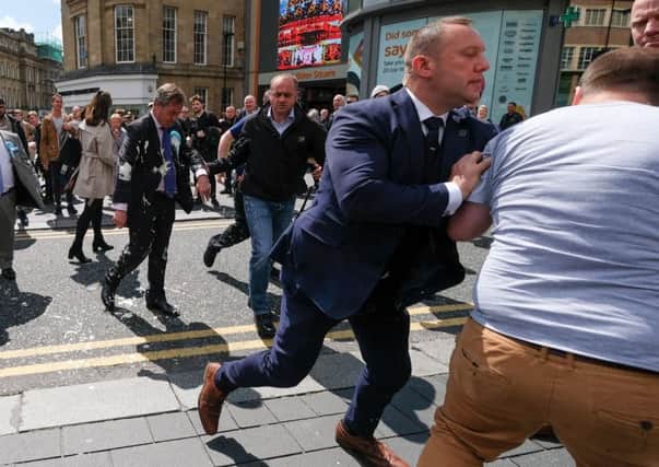 Nigel Farage has what appears to be milkshake thrown on him in Newcastle (Picture: Ian Forsyth/Getty Images)