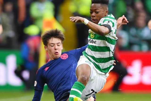 Celtic's Karamoko Dembele is tackled by Hearts' Aaron Hickey. Picture: SNS