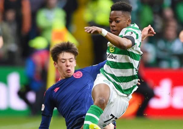 Celtic's Karamoko Dembele is tackled by Hearts' Aaron Hickey. Picture: SNS