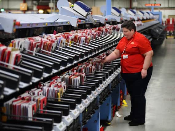 The core business remains the delivery of letters and parcels. Picture: John Devlin