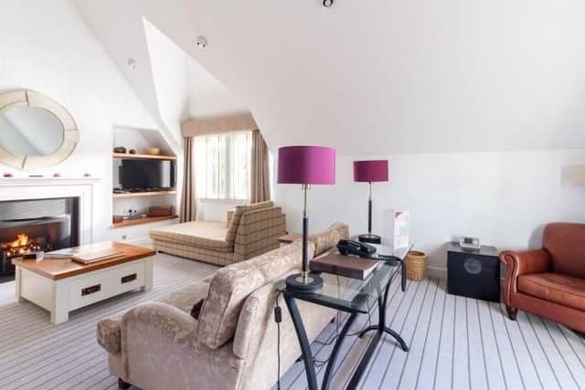 The living room has a range of seating and a stylish design.