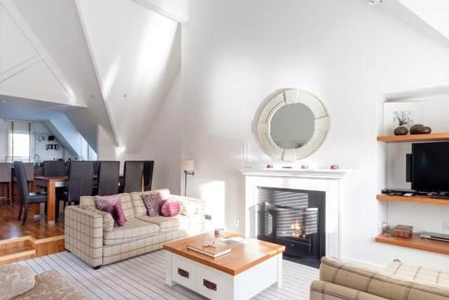 The living room, kitchen and dining space are all found in this open plan space.