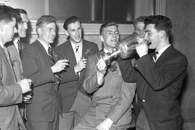 Hearts players drink champagne from the Scottish Cup after their 3-1 win over Celtic in the 1956 final. Picture: TSPL
