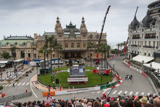 Lewis Hamilton steers his car around the square in front of the Monte Carlo Casino during first practice for the Monaco Grand Prix. Picture: PA.
