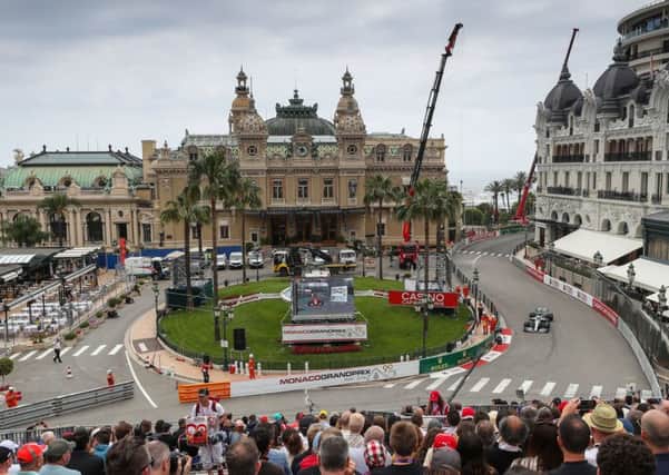Lewis Hamilton steers his car around the square in front of the Monte Carlo Casino during first practice for the Monaco Grand Prix. Picture: PA.