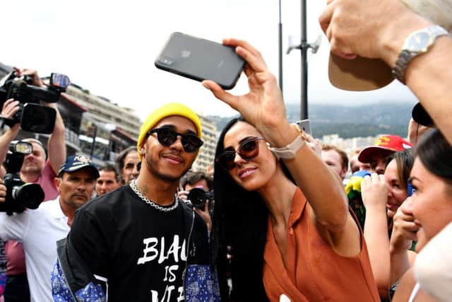 Lewis Hamilton poses for a selfie with a fan in Monte Carlo. Picture: Michael Regan/Getty