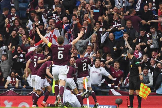 Hearts' players celebrate Ryan Edwards' opener with the fans. Pic: SNS/Craig Williamson