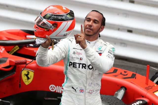 Lewis Hamilton points to Niki Lauda's name on the back of his helmet after claiming victory in the Monaco Grand Prix. Picture: David Davies/PA