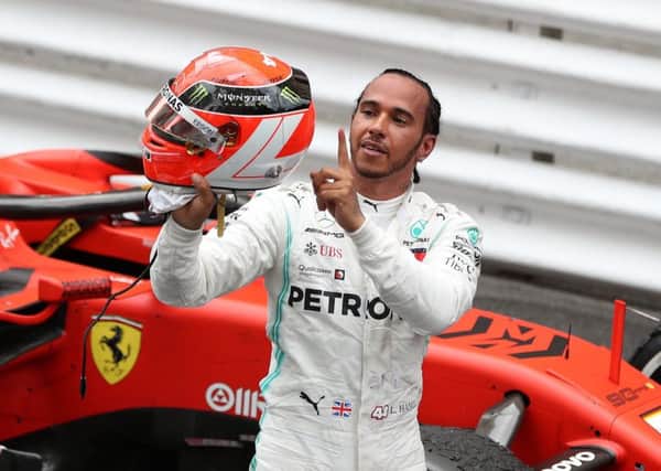 Lewis Hamilton points to Niki Lauda's name on the back of his helmet after claiming victory in the Monaco Grand Prix. Picture: David Davies/PA