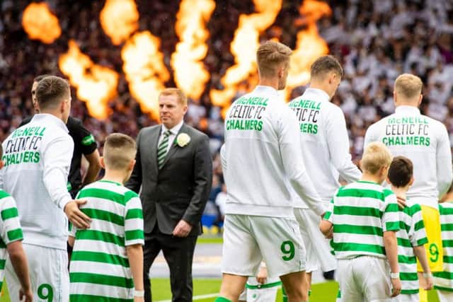 Celtic won their ninth successive trophy with a 2-1 win over Hearts at Hampden.