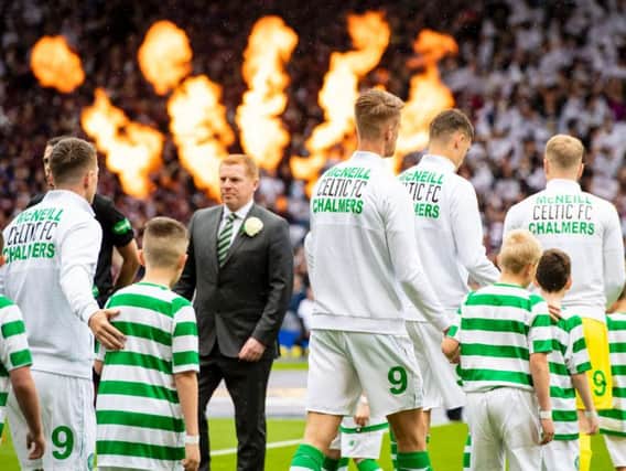 Celtic won their ninth successive trophy with a 2-1 win over Hearts at Hampden.