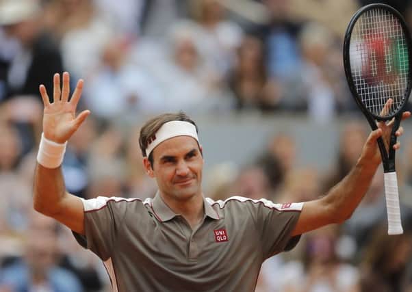 Roger Federer acknowledges the crowd at the French Open as they welcome him back to Roland Garros. Picture: AP.