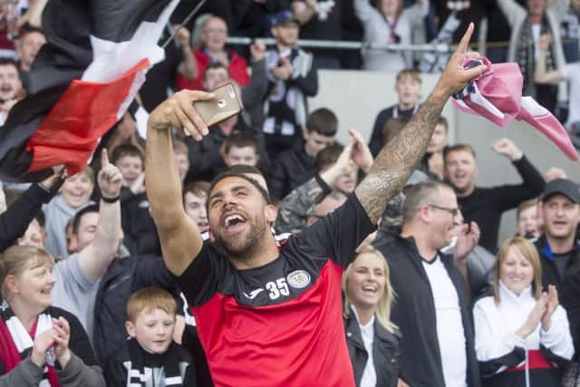 Anton Ferdinand takes a selfie while celebrating with the St Mirren fans after the Paisley clubs play-off victory over Dundee United. Picture: PA.