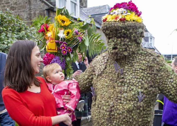 One-year-old Edith McQuatt and her mum Laura meet the Burryman as he takes to the streets of South Queensferry as part of the annual ritual.