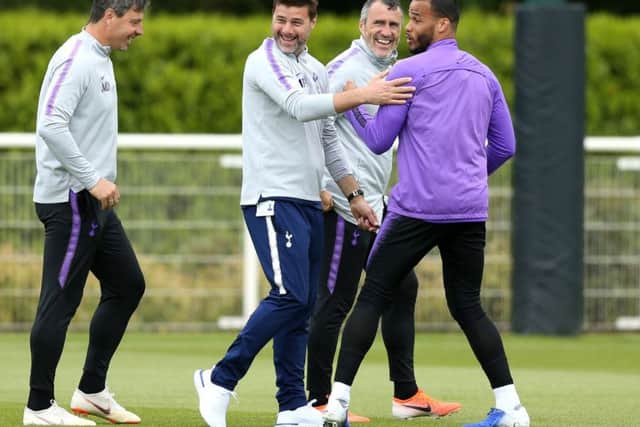 Spurs manager Mauricio Pochettino, centre, enjoys a joke during a training session. Picture: Paul Harding/PA