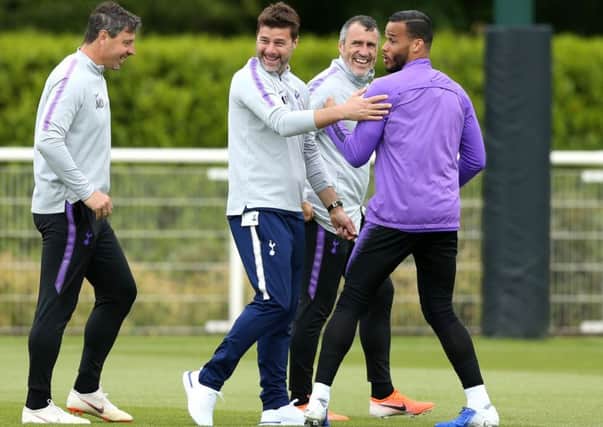 Spurs manager Mauricio Pochettino, centre, enjoys a joke during a training session. Picture: Paul Harding/PA