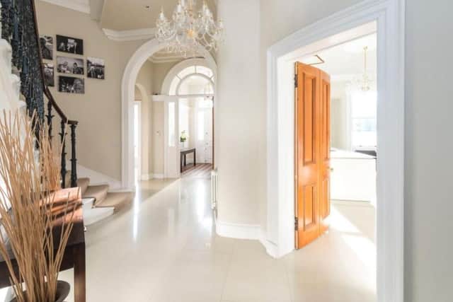 The entrance hallway leads into the living room and dining kitchen.