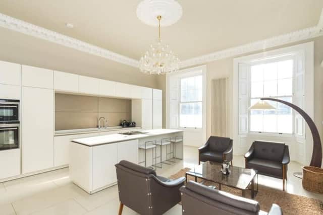 The modern kitchen has a sitting area.
