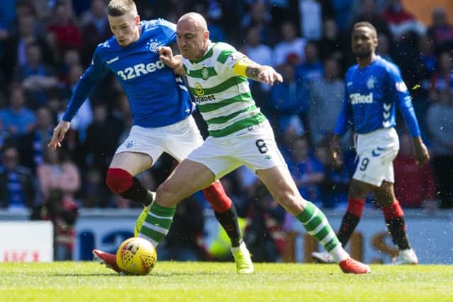 Celtic skipper Scott Brown shows typical tenacity as he battles with Rangers winger Ryan Kent. Picture: Ross Parker/SNS