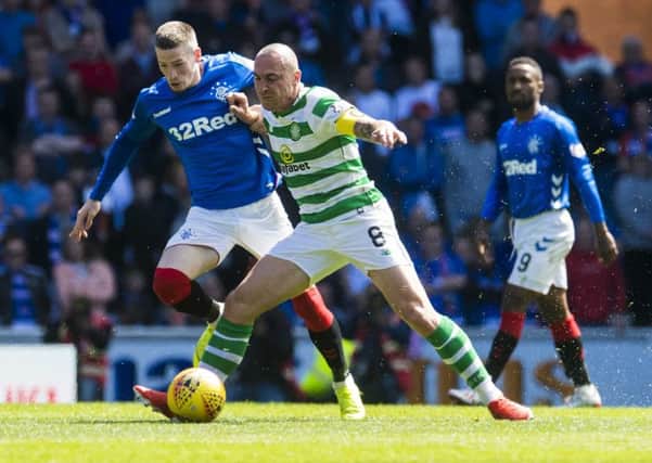 Celtic skipper Scott Brown shows typical tenacity as he battles with Rangers winger Ryan Kent. Picture: Ross Parker/SNS