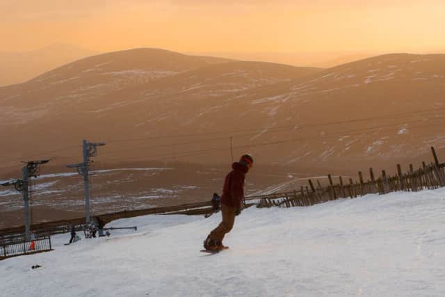 A snowboarder enjoying the views at the Lecht