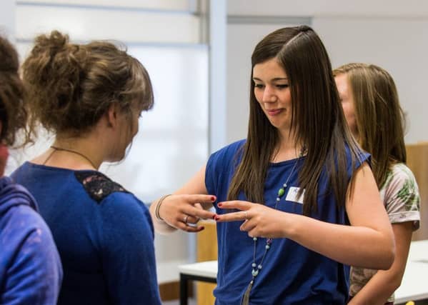 Photograph by Ian Georgeson Pic: Kirsty McEwen try's out some sign language. Secondary school pupils from schools across Edinburgh the Lothians, Borders and Fife will take part in a British Sign Language (BSL) workshop at Heriot-Watt University's Brightest Watts summer week. A highly interactive session pupil's will experience what it's like to communicate without using spoken words, and to focus on visual modes of communication. They will have the opportunity to learn and practice some BSL. When? Tuesday 16 July, 10.30am to 12.30pm Where? Heriot-Watt University, Edinburgh Campus, BEC Lecture Theatre, Esmee Fairbairn Building Who? 19 pupils due to go on to fifth year after the summer will join this workshop being led by Gary Quinn, BSL Teaching Fellow, Heriot-Watt University