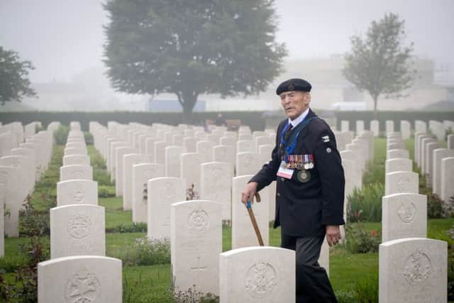 Normandy veteran Edwin 'Ted' Hunt walks past the graves of fallen in 2018. Picture: Getty