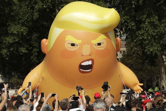 A six-meter high cartoon baby blimp of U.S. President Donald Trump is flown as a protest against his last visit to the UK in 2018