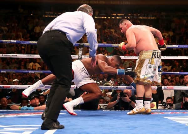 Anthony Joshua is dropped to the canvas for the fourth time by Andy Ruiz. Picture: PA.