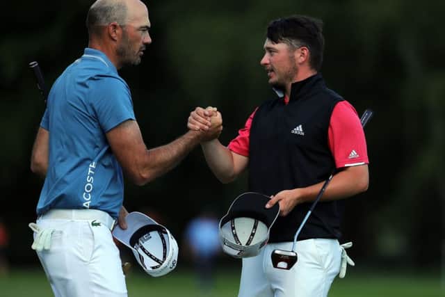 Ewen Ferguson, right, shakes hands with Gregory Havret. Picture: Getty.