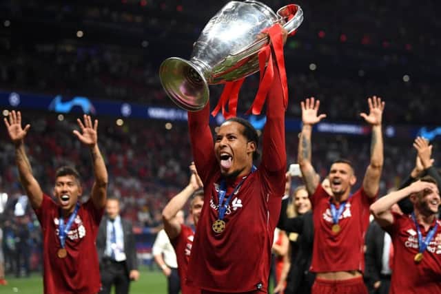 Virgil Van Dijk sticks his tongue out as he lifts the Champions League trophy. Picture: Getty.