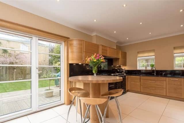 The modern kitchen has a small dining area.