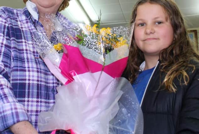North Bute Primary's Abigail MacGregor (P.7) presents 'For Bute's Marlene Hill with her floral 'thank you'