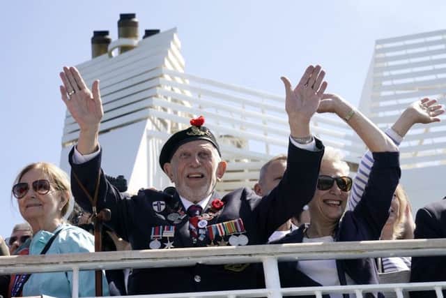 D-Day Veteran Joe Cattini, 95, who was in the Hertfordshire Yeomanry and landed on Gold Beach on D-Day, waves after boarding a Brittany ferry to Caen and the Normandy beaches to pay their respects to fallen comrades. Picture: Christopher Furlong/Getty Images
