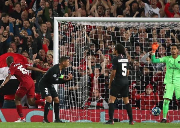 Daniel Sturridge, left, turns away after scoring  Liverpools opening goal in the 3-2 defeat of PSG last September. Picture: PA.