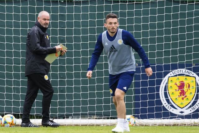 Steve Clarke runs the rule over midfielder and man of the moment John McGinn at the Oriam as the manager oversees his first Scotland training session. Picture: SNS.