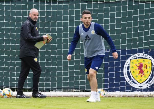 Steve Clarke runs the rule over midfielder and man of the moment John McGinn at the Oriam as the manager oversees his first Scotland training session. Picture: SNS.