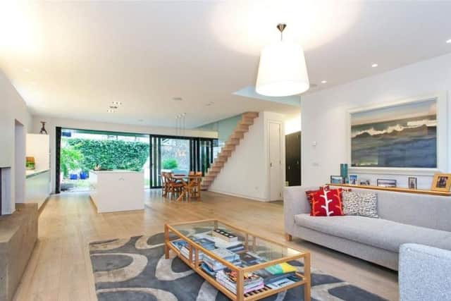The open plan living room/kitchen/dining space has a 'floating' staircase.