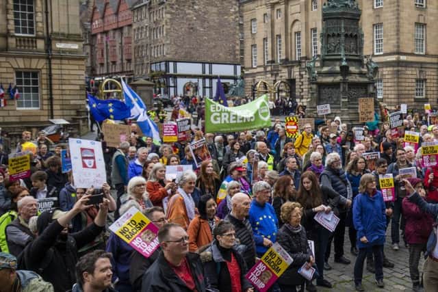 Hundreds of people protest against Donald Trump's State visit outside St Giles Cathedral in Edinburgh.  Picture: Duncan McGlynn