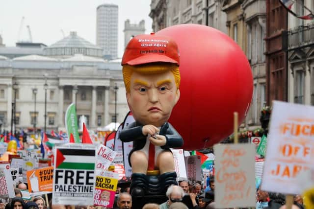 An effigy of Donald Trump is carried by protestors demonstrating against the visit of US President. Picture: Getty Images.