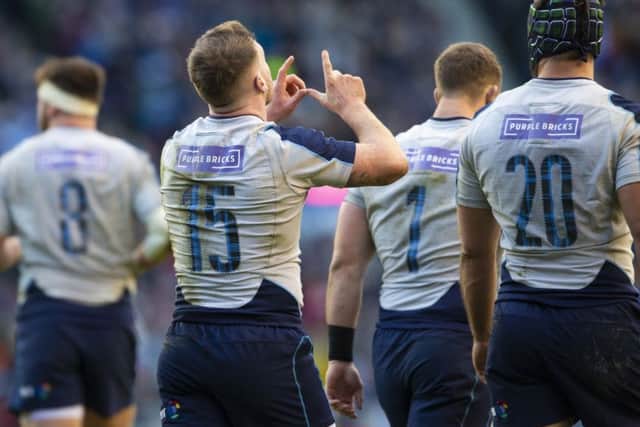 Hogg makes his signature 'W' celebration in memory of his late best friend Richard Wilkinson after scoring a try in the Guinness Six Nations match against Italy this year.